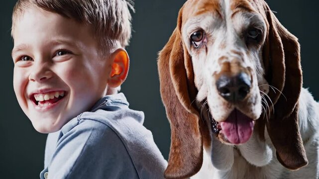 Joyful boy with bright smile posing with happy basset hound dog portrait
