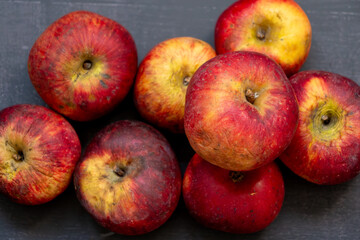 A bunch of apples with a few of them being rotten