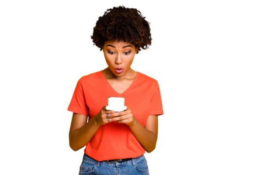 Photo of black american girlfriend holding telephone seeing dislikes on her blog wearing jeans denim t-shirts while isolated with yellow vivid color background