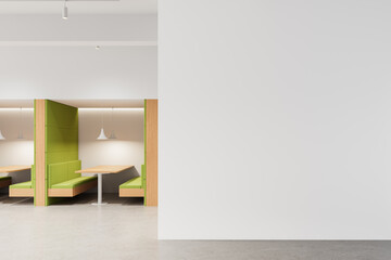 Modern interior with green booth seating and blank white wall for poster mockup or design template in clean minimal layout concept. 3D Rendering