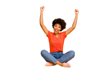 Full length body size photo of cheerful kind cute sweet fascinating girlfriend sitting with her legs crossed wearing jeans denim isolated over yellow vivid color background