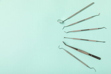 Dentist tools on a blue background. Dentist Concept.Teethcare, dental health concept. Means to care for the oral cavity. Dental model and dental equipment. Dental hygiene. Space for text. Copy space.