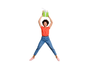 Full size photo of excited amazed girl hold gift for anniversary 8-march 14-february jump feel delighted crazy wear red stylish trendy denim outfit isolated over yellow color background