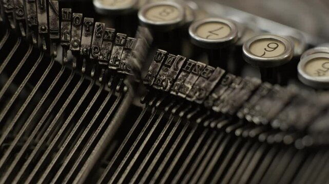 Vintage typewriter letter impact stamp moving while typing on keyboard close up