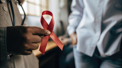 Red ribbon symbol representing awareness for sexually transmitted infections, healthcare and medical campaign concept for prevention and education.