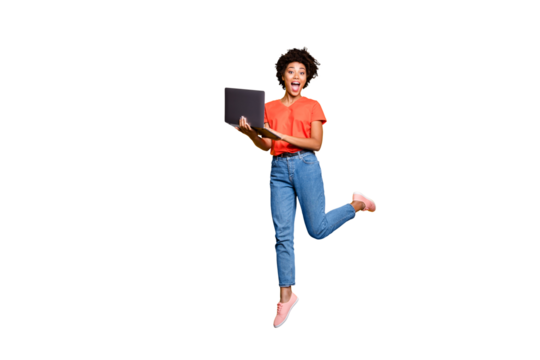 Full size photo of amazed crazy curly brown hair girl use her laptop have notification in feednews jump scream omg wear denim jeans red t-shirt lifestyle sneakers isolated yellow color background