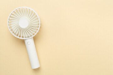 Mini electric fan on color background, top view
