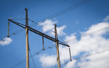 Poles with high voltage wires against the blue sky 2