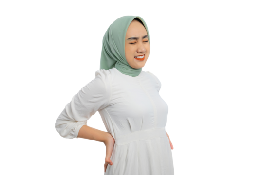 Beautiful young Asian woman in green hijab and white blouse suffering from lower back pain isolated on transparent background