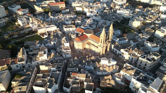 Alberobello panoramic view: An awe-inspiring aerial view unveils the architectural grandeur of a timeless church nestled within a close-knit neighborhood.