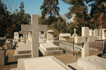Christian graveyard, cross tombstone, Historical graveyard with tombstones, Silent resting place among trees, Crosses in a peaceful cemetery, Tombstones of Polish Christians, old stone graves