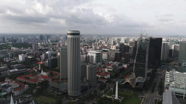 AXA Tower and more buildings on a gloomy day in Singapore, drone view