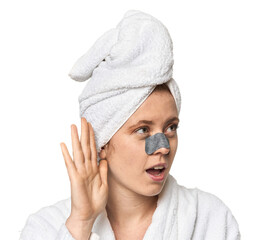 Young Caucasian redhead with pore strip trying to listening a gossip.