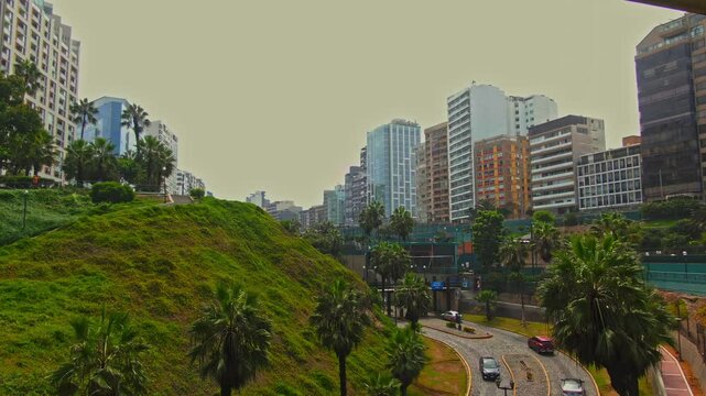 Pull out drone shot under Eduardo Villena Rey Bridge during the day in Malecon de Miraflores in the coast of Lima, Peru