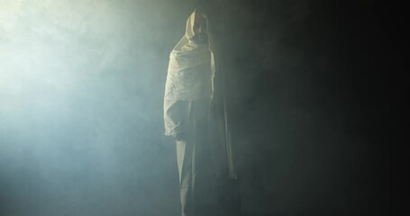 Jesus Christ shrouded in ambient bright light, symbolizing the resurrected Jesus Christ inside the tomb in bright, dramatic, glowing, holy light as representation of the Easter Sunday resurrection.