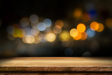 empty wooden table top on blur light golden bokeh of cafe restaurant, bar in a dark background, for your photo montage or product display, Space for placing items on the table.	