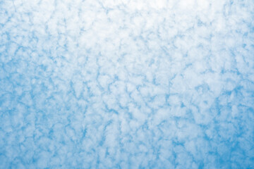 Bright blue sky with fluffy white clouds on a sunny day