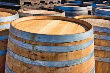 Close-up of old wooden barrels in a winery.