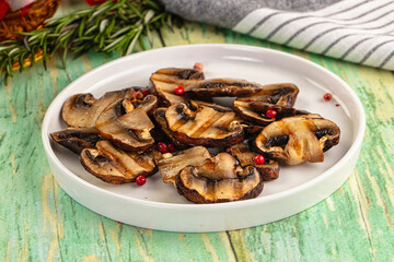 Tasty hot grilled champignon mushrooms