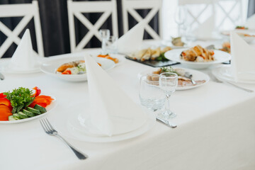 Elegant dining setup with assorted dishes and cutlery for a formal gathering