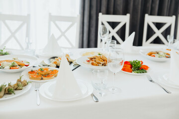 Elegant dining setup with gourmet dishes and decorative table linens