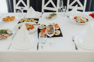 Elegant dining table set with gourmet dishes in a bright setting