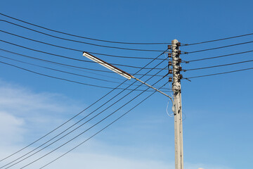 power lines and communication lines on electric poles with the blue sky