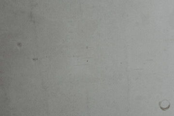 Plain white wall with subtle texture and marks from previous use