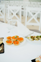 Gourmet appetizers served at a stylish dining event in a modern venue