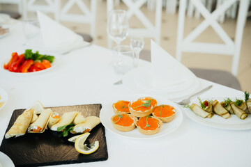 Delicious appetizers served on a white table for a festive gathering