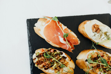 Tasty appetizers featuring various toppings on toasted bread slices