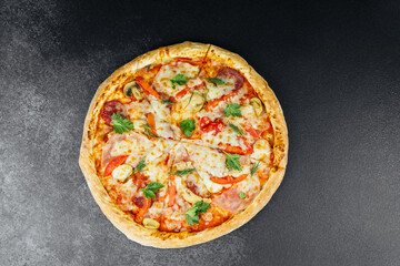 Delicious freshly baked pizza with various toppings on a dark background