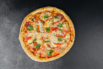 Delicious pizza with fresh toppings served on a dark textured surface