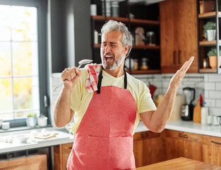 kitchen man food preparing home senior happy adult fun cooking singing music dancing cheerful joy...