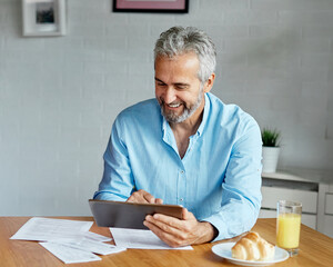 man senior bill finance home budget mature business businessman technology computer working tablet...