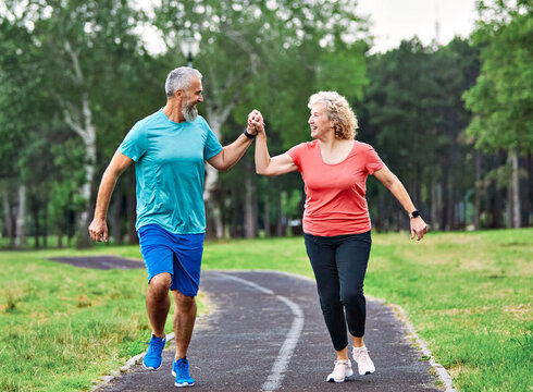 fitness woman man active sport exercise together jogging healthy fit running teamwork middle aged mature middle age runner jogger