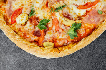 Delicious pizza topped with meat, vegetables, and herbs on a wooden table