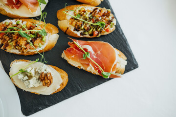 Delicious gourmet bruschetta served on a dark slate board