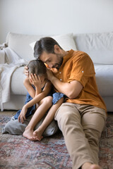 Compassionate caring father sit on floor close to sad suffering distressed preteen girl support...
