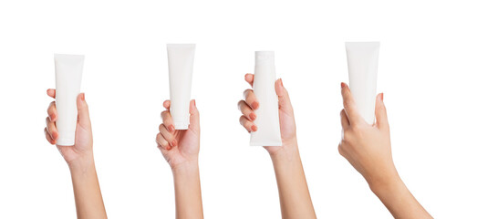 Female hand holding blank cosmetic bottle isolated on white background
