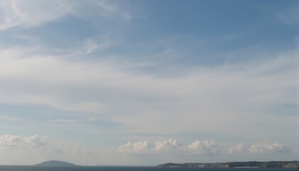 Fototapeta premium Cloudscape Over The Horizon: A panoramic vista showcasing the serene beauty of the open ocean under a sky adorned with billowing clouds, creating a sense of vastness and tranquil escape.