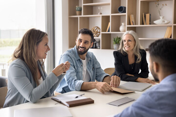 Diverse ideas in team vision. Successful creative multiethnic group of corporate workers gather at briefing table in office exchange opinions present insights brainstorm solutions for business problem