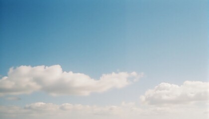 Cloudscape Serenity: A clear blue sky canvas adorned with fluffy, cotton-like clouds. The scene radiates peace and calm, perfect for evoking a sense of boundless freedom. 