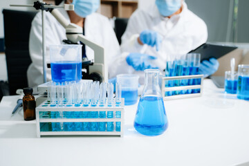Fototapeta premium scientists in lab coats conducting research, handling glassware, and working with chemicals
