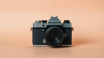 Fototapeta premium A vintage film camera centered on a pastel peach background, with soft shadows and ample negative space