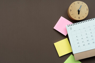 close up of calendar and clock on the brown table background, planning for business meeting or travel planning concept
