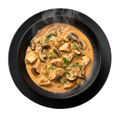 Chicken stroganoff with mushroom sauce on black plate isolated on white background