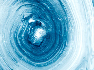 Abstract image with swirling blue and white paint texture forming a dynamic vortex. Сreative hand painted background.