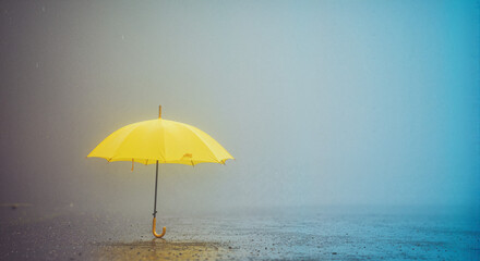 Yellow Umbrella in Rain &ndash; Symbol of Hope and Brightness in Grey Weather

