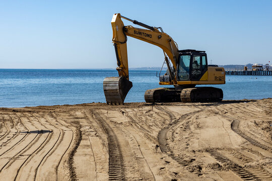 Side, Antalya, Turkey - March 15 2025: Sumitomo excavator working on the beach to prepare for the new tourist season on the Mediterranean coast.